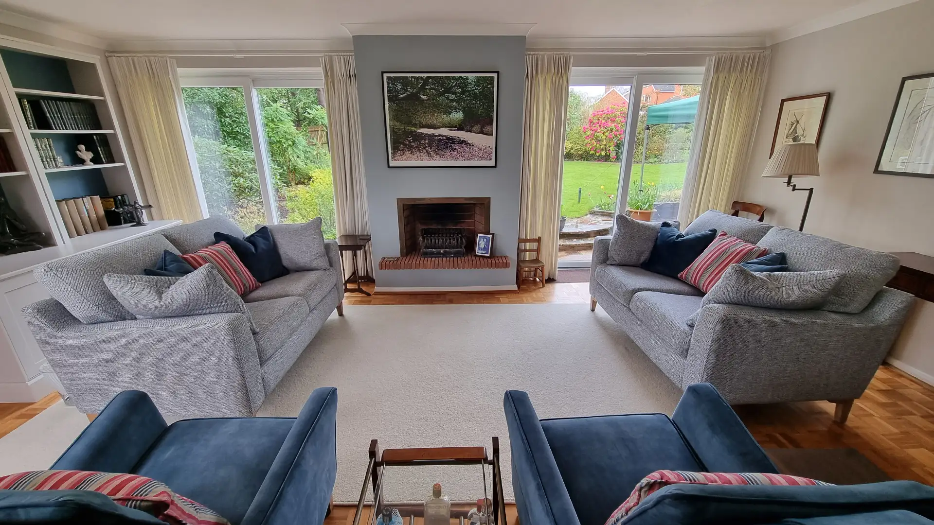 Blue textured sofa, velvet chairs and soft grey wall colour